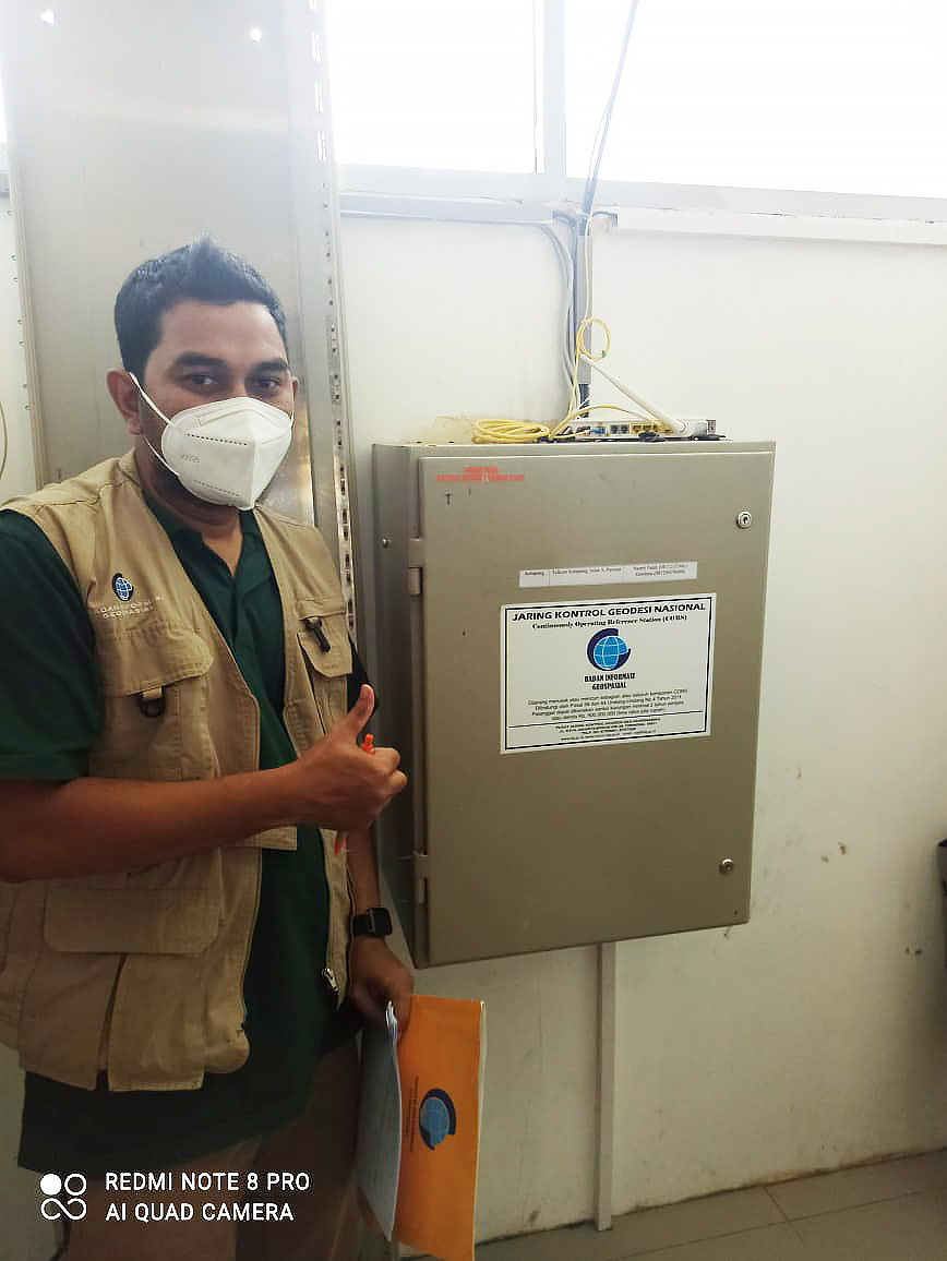 Munawar Kholil with a GNSS box panel